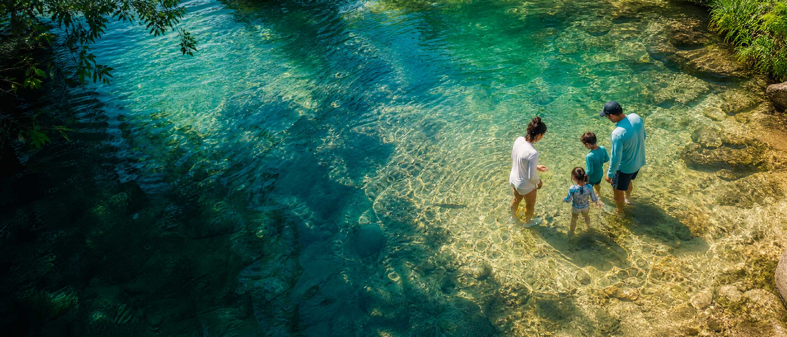 Família aproveitando a água em um cenário natural